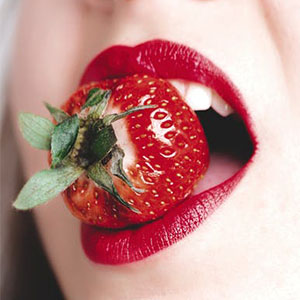 Sexy women holding strawberry in mouth